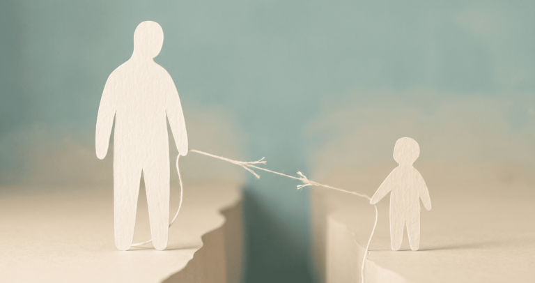 parental-alienation - Two paper-cut figures - one large, one small - standing on opposite sides of a widening gap